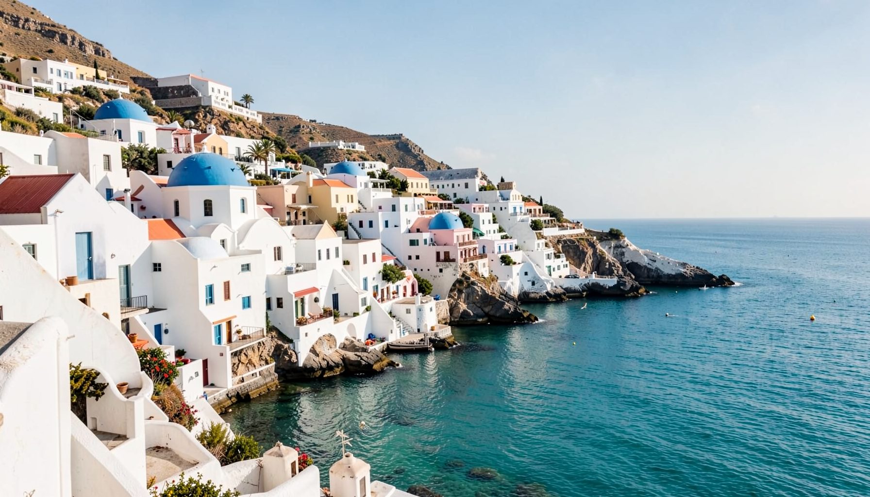 Sunlit whitewashed coastal village with blue-domed buildings overlooking a calm turquoise sea, warm and inviting Mediterranean atmosphere